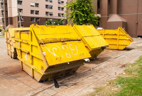 Workers handling commercial waste with PPE at collection point